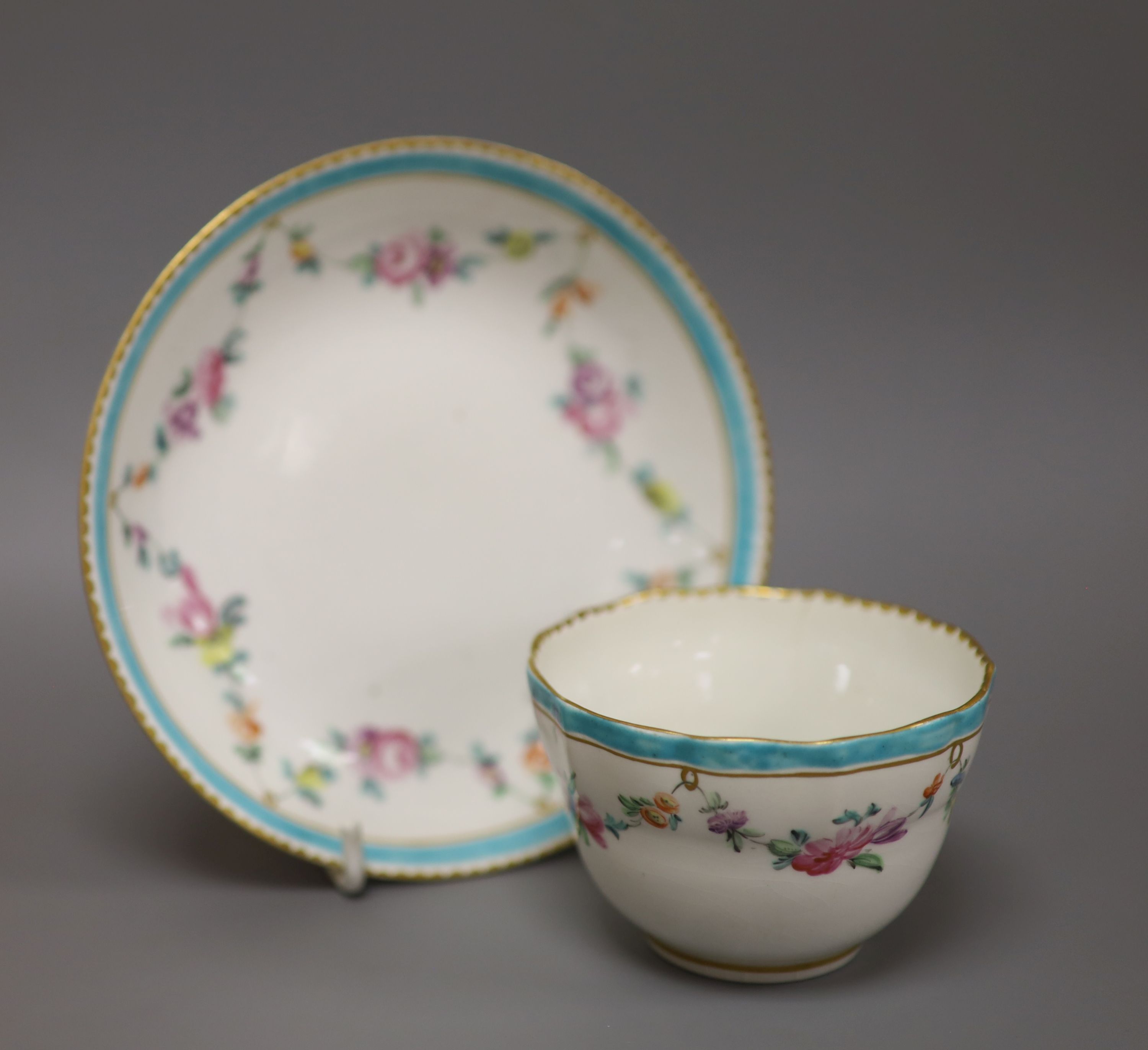 A Chelsea Derby teabowl and saucer painted with flowers, c.1778, blue Crown Derby mark with no batons, diameter 13cm